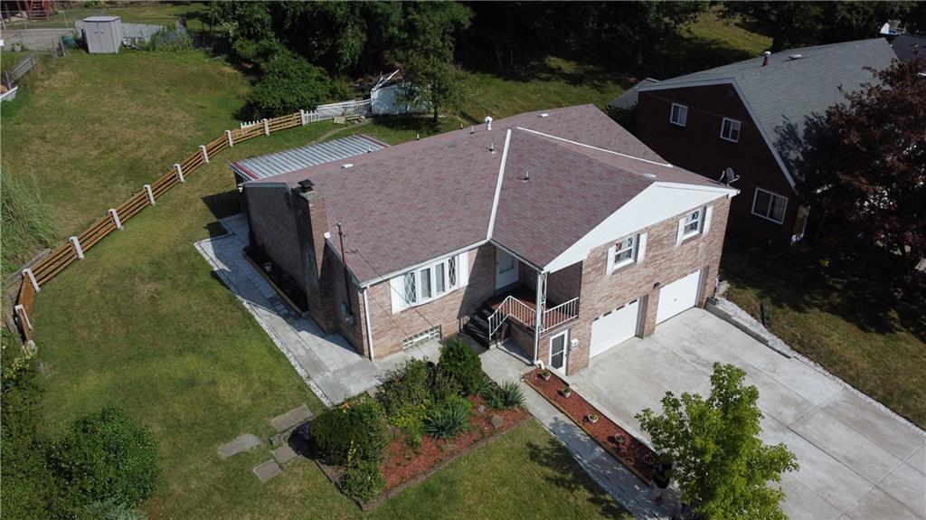 an aerial view of a house with swimming pool and garden