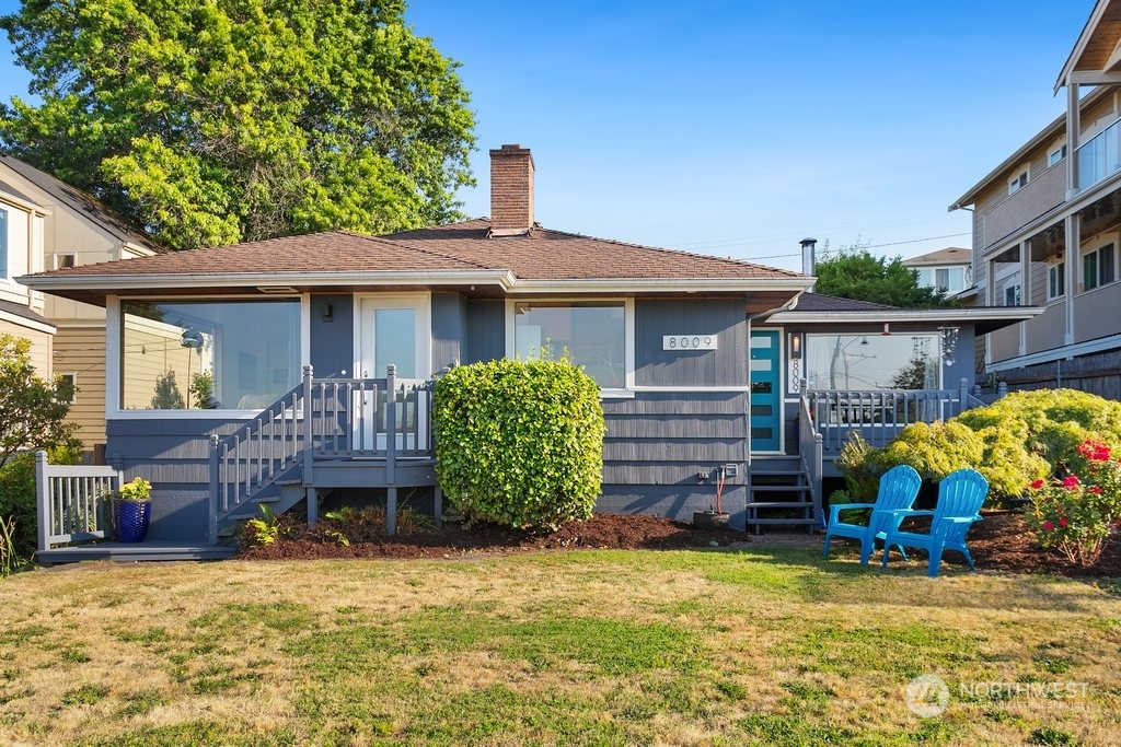 a view of a house with a yard and furniture