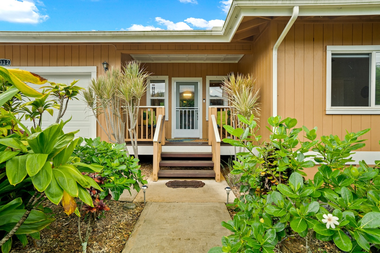 a front view of a house with garden