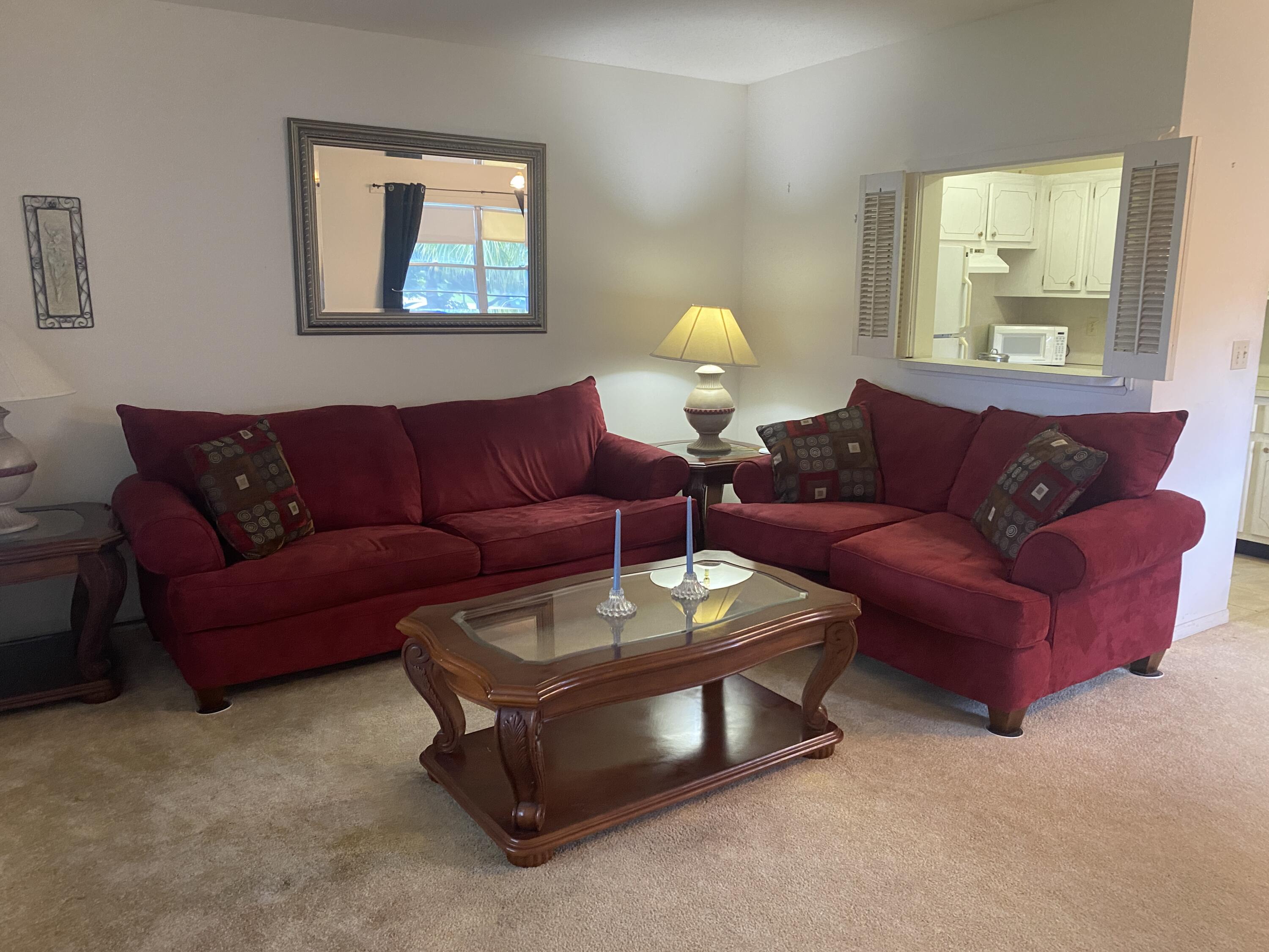 a living room with furniture a couch and paintings on the wall