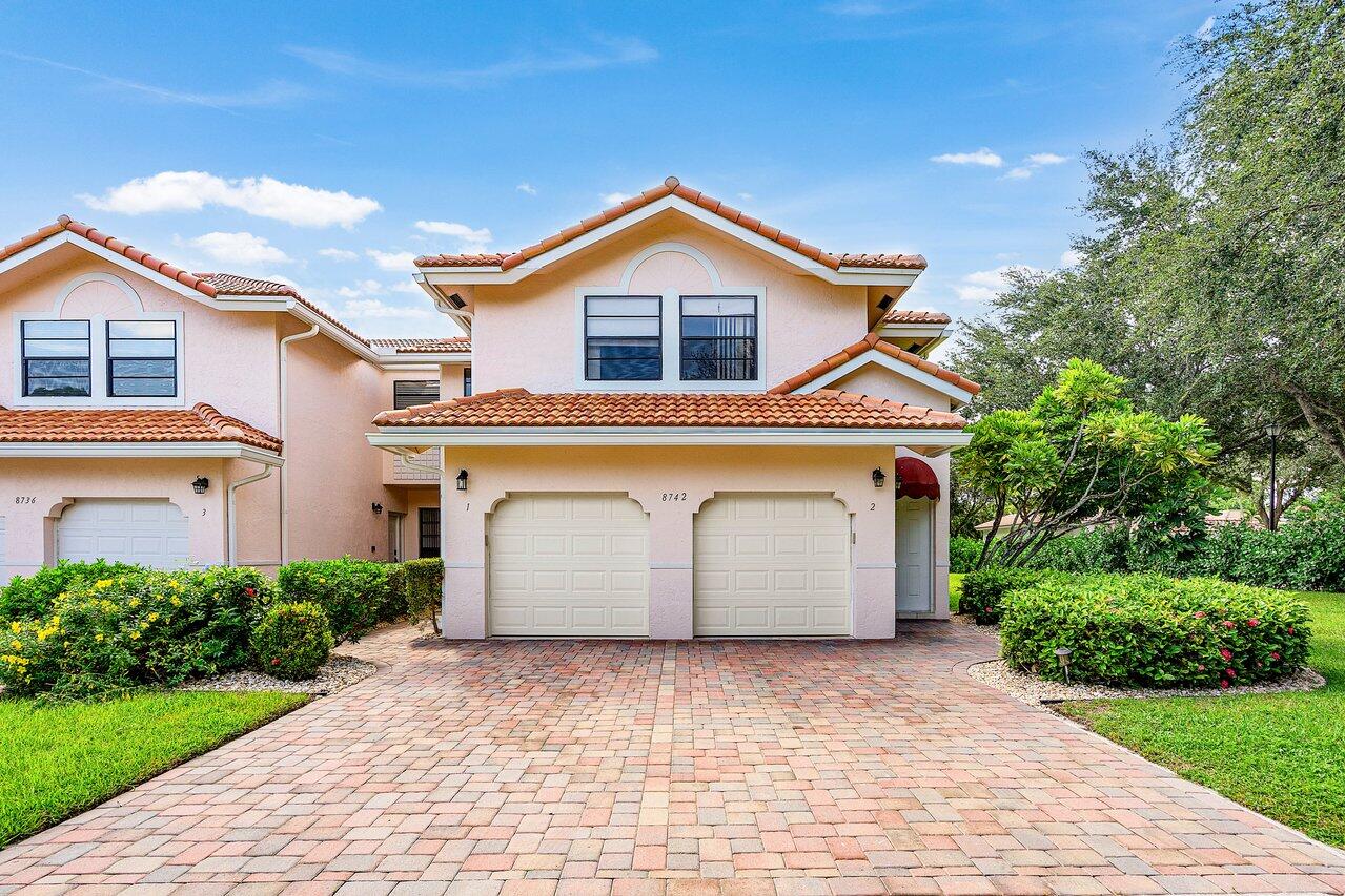 a view of a house with a yard and garage