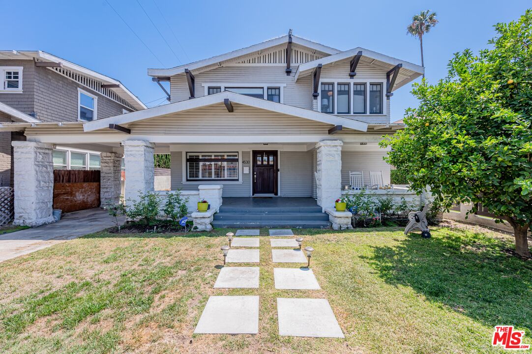 a front view of a house with yard and green space