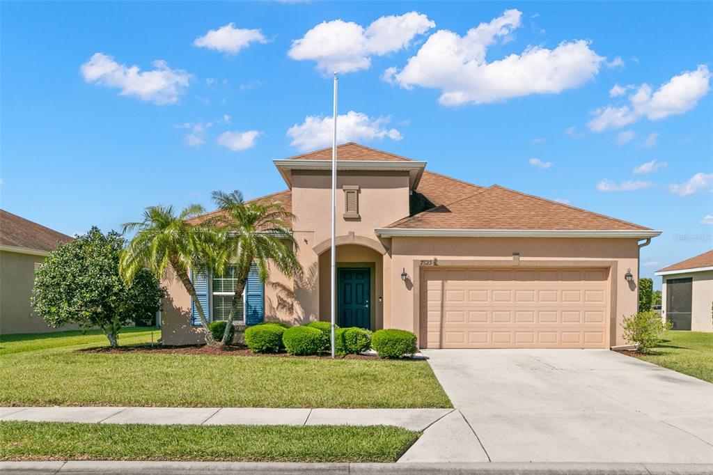 a front view of a house with a yard and garage