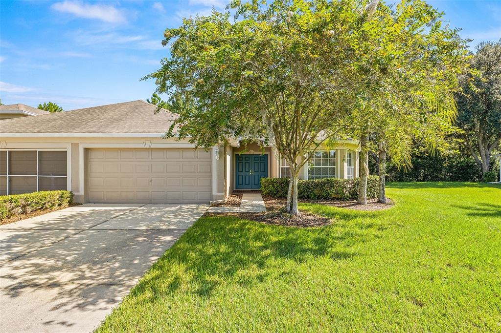 a front view of a house with a yard and garage