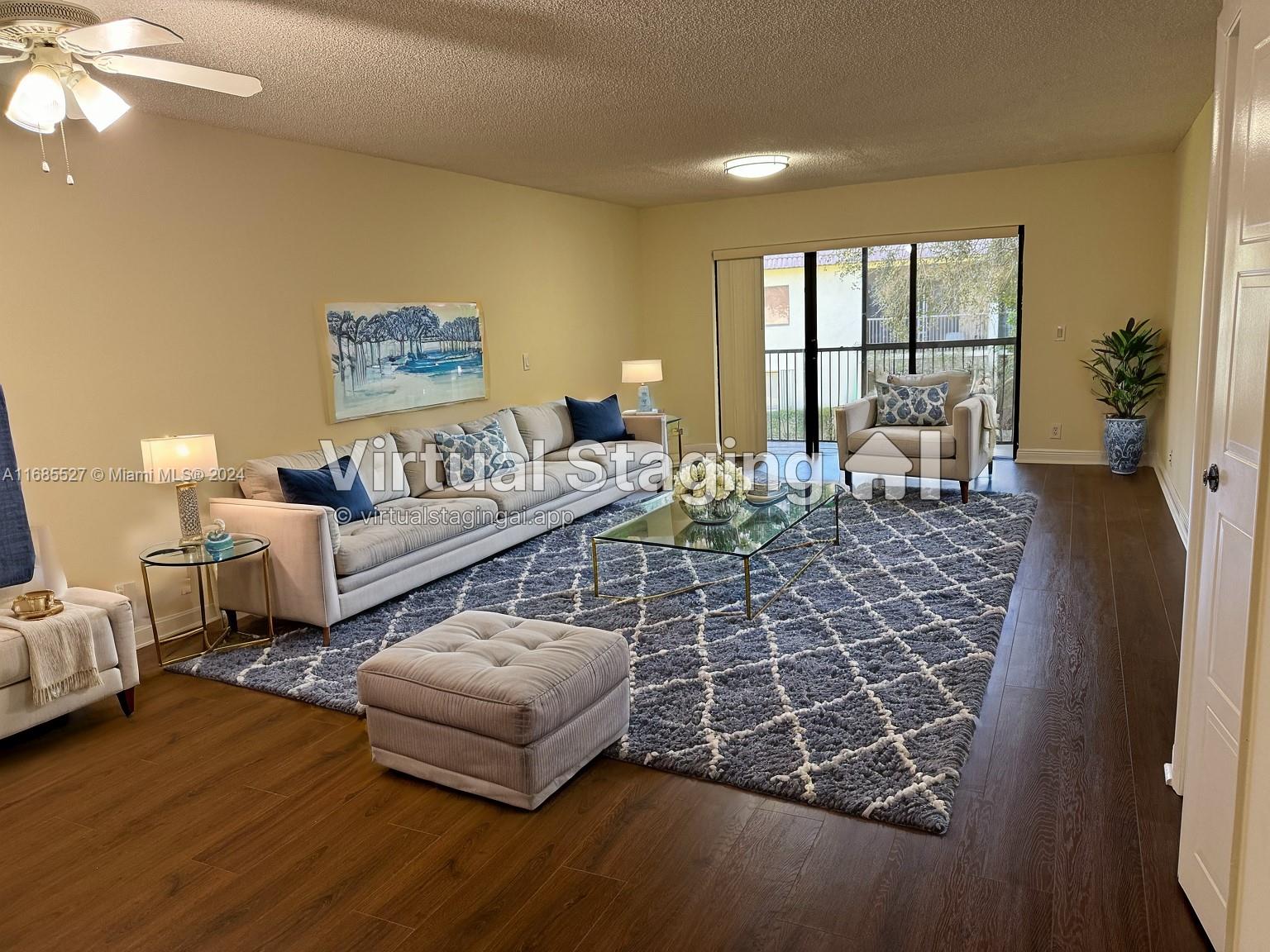 a living room with furniture and a floor to ceiling window