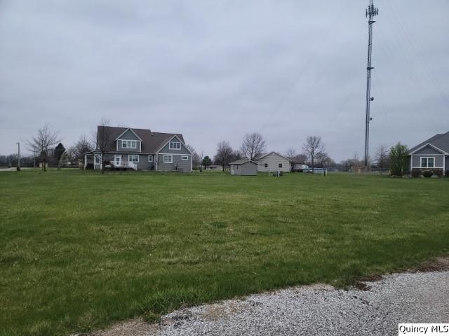 a view of a field of grass and trees