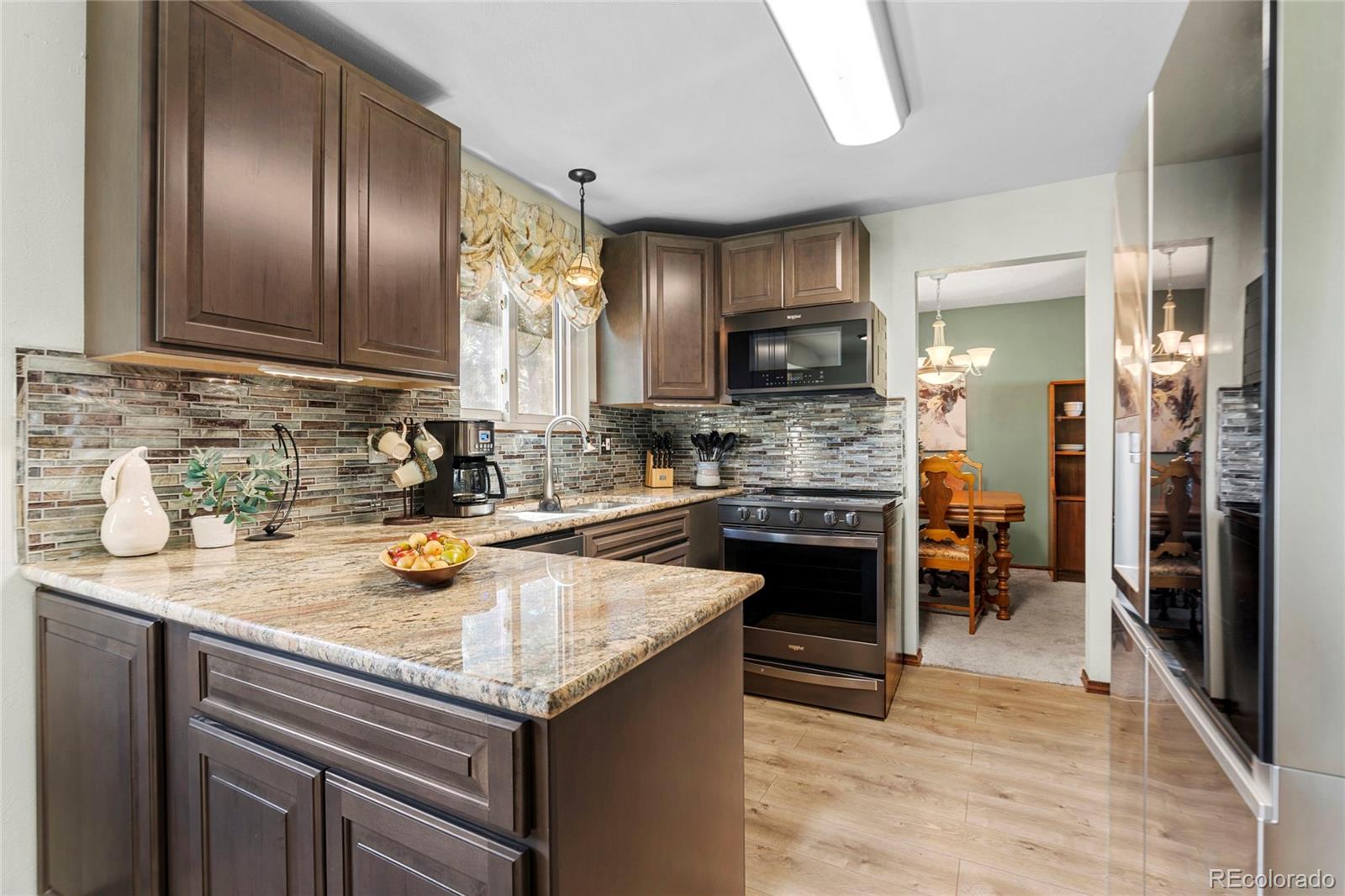 a kitchen with a sink appliances and cabinets