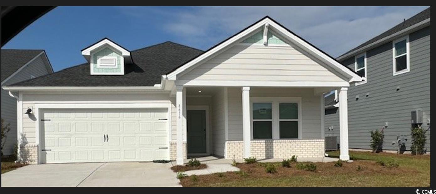 View of front facade featuring a garage