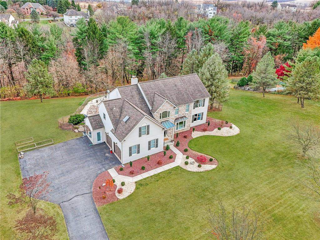 an aerial view of a house with a yard basket ball court and outdoor seating