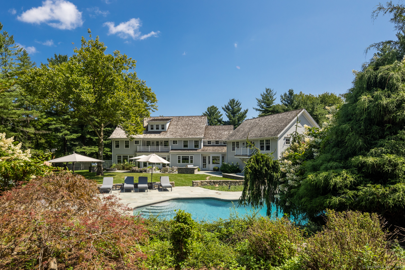 a view of swimming pool with outdoor seating and a garden