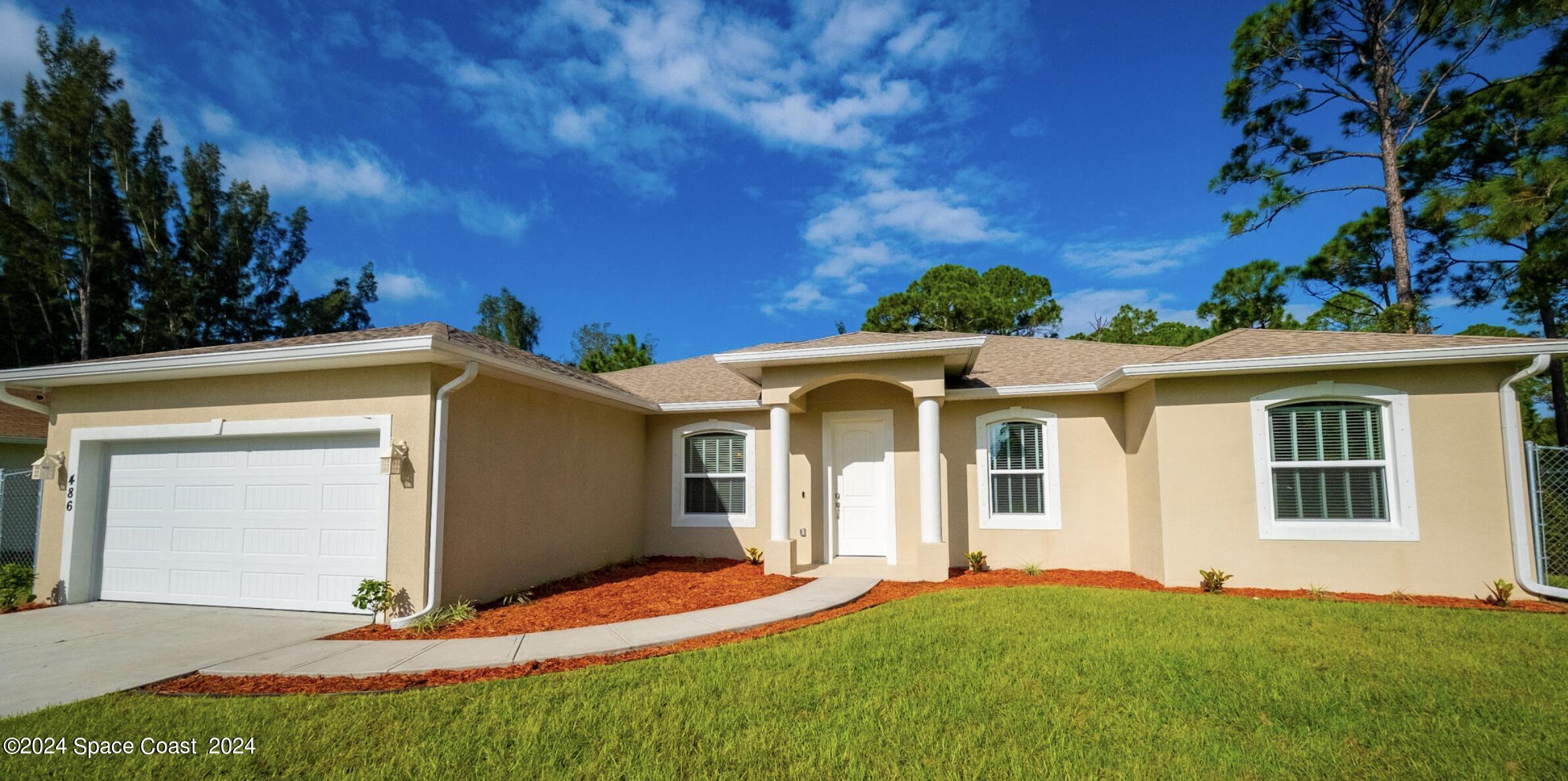 a front view of a house with a yard