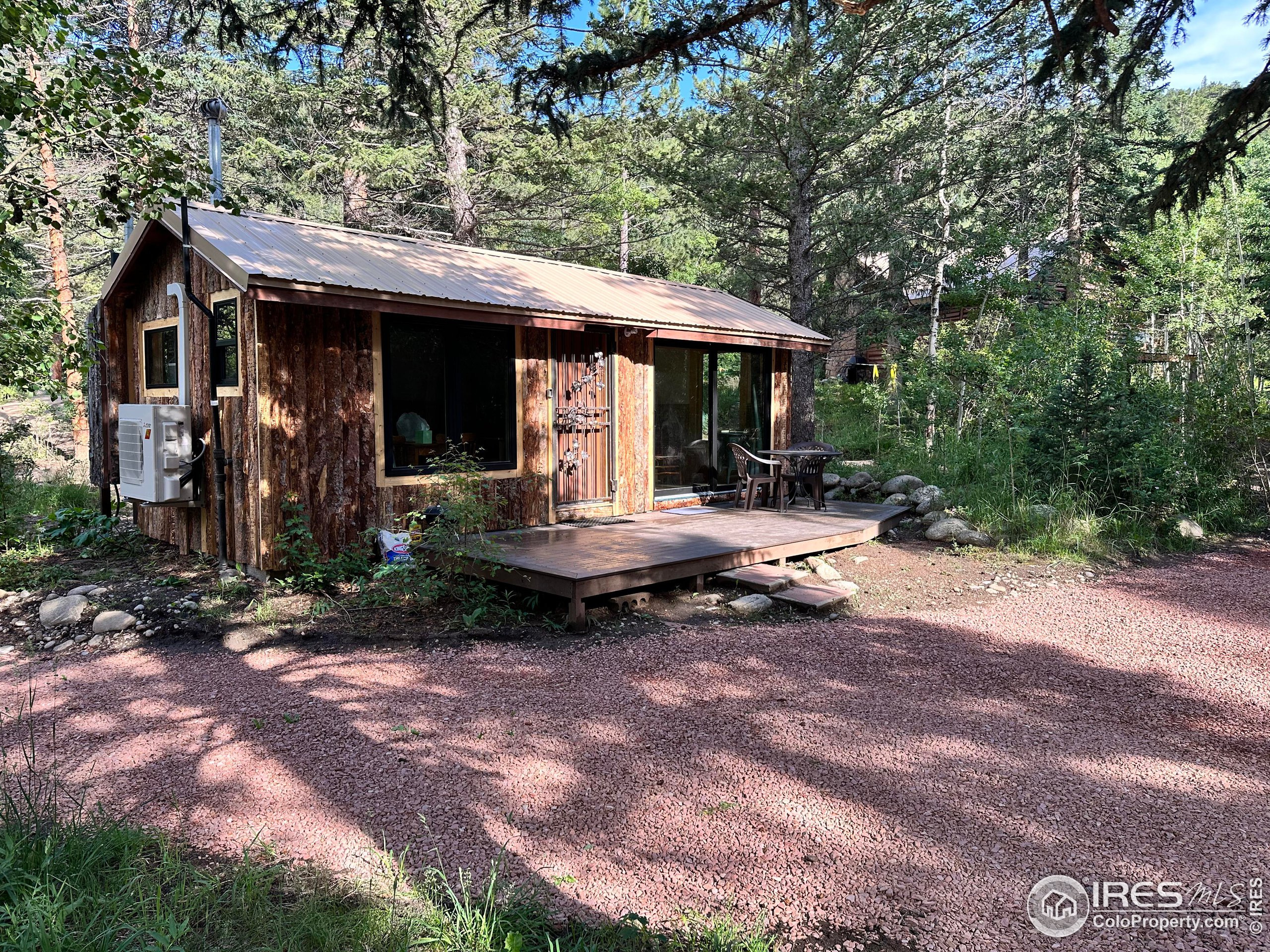 a backyard of a house with barbeque oven fire pit table and chairs