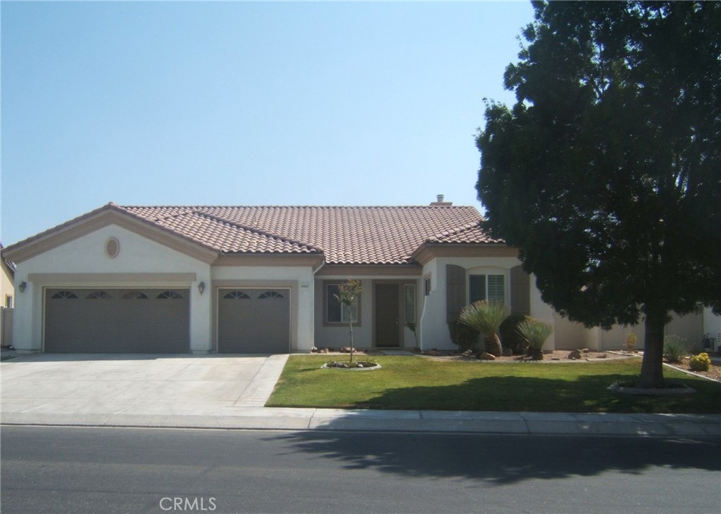 a front view of a house with a garden and plants