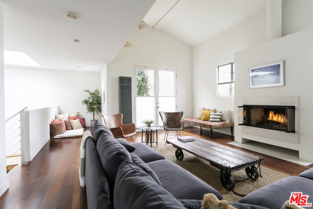 a living room with furniture a table and a fireplace