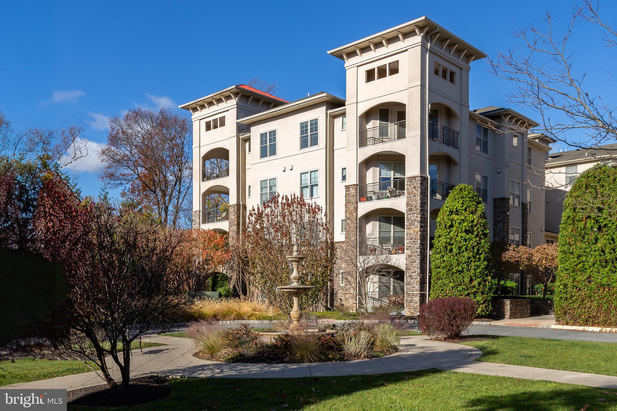 a front view of a residential apartment building with a yard