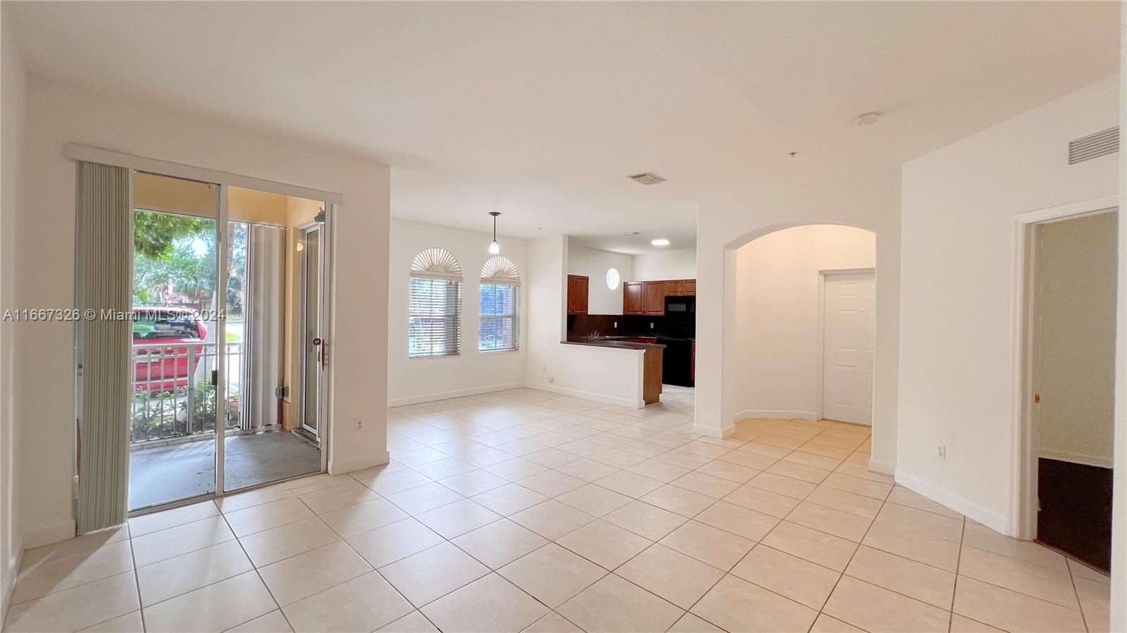 a view of a refrigerator in kitchen and a living room