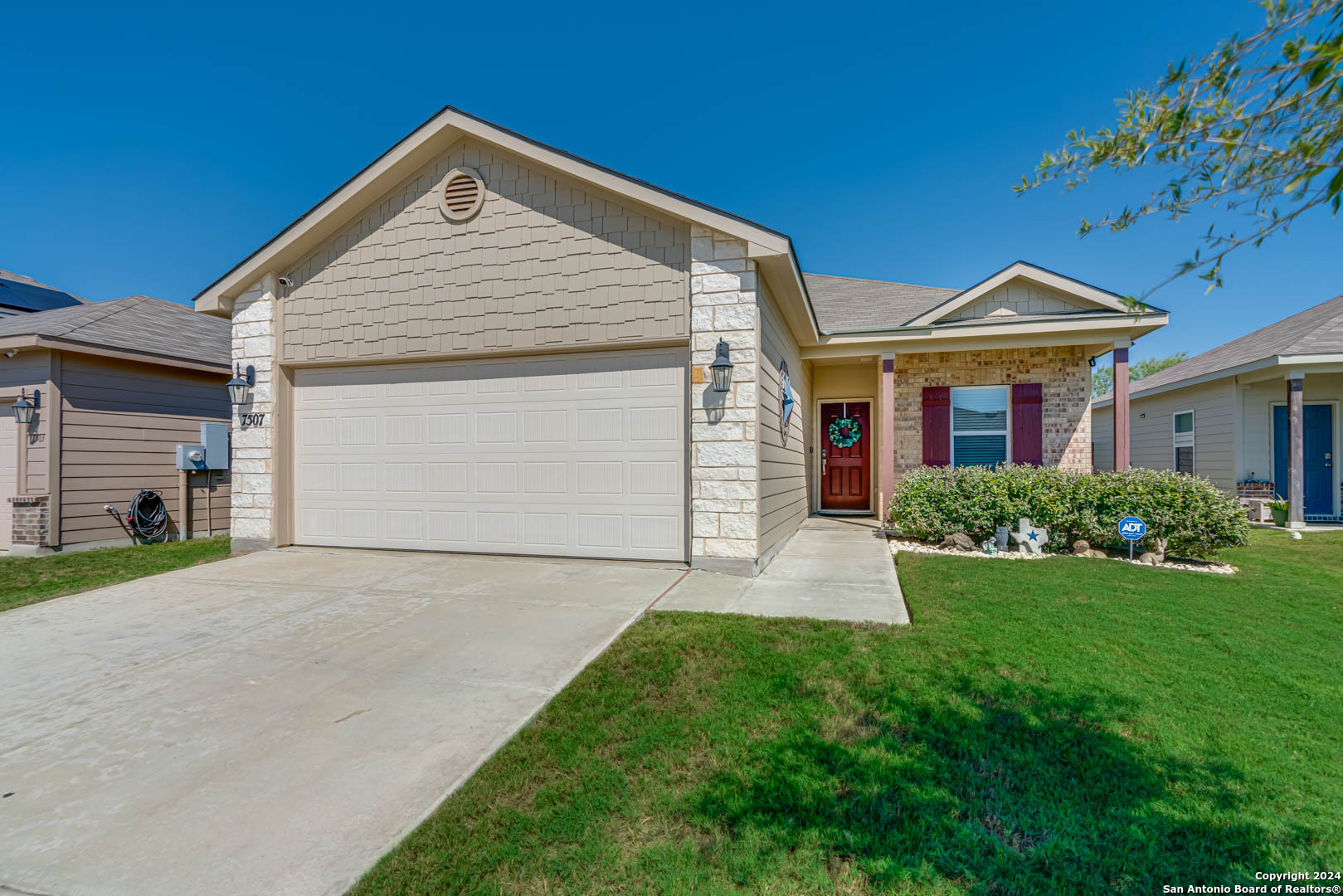 a front view of a house with a yard and garage