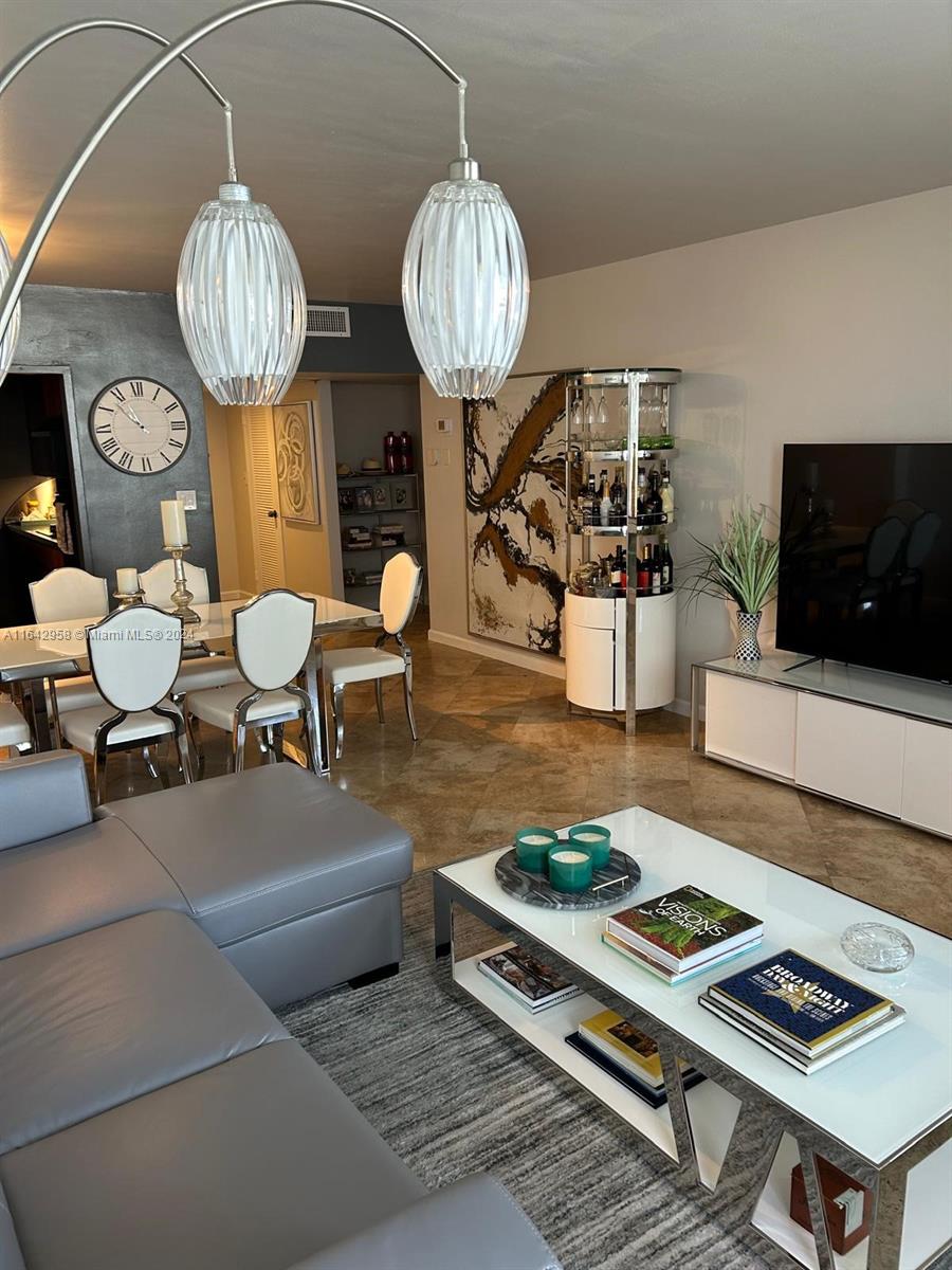 a living room with furniture a table and a flat screen tv