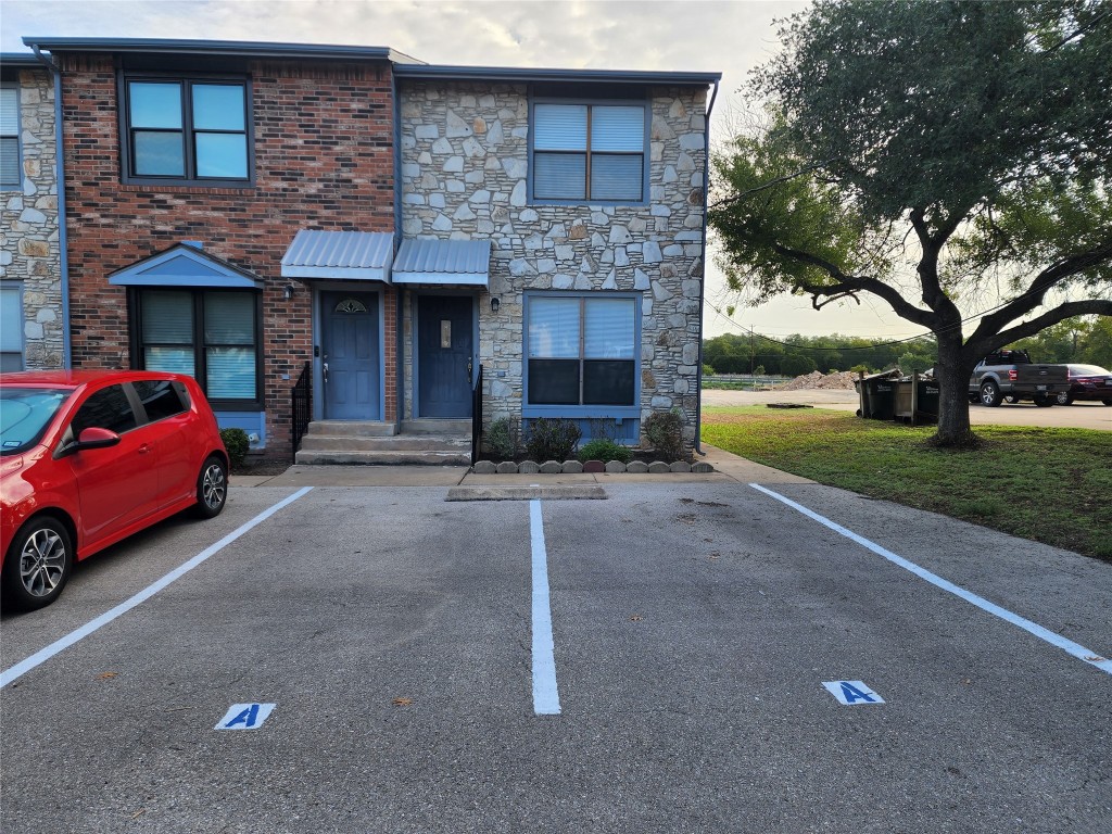 a car parked in front of a brick house