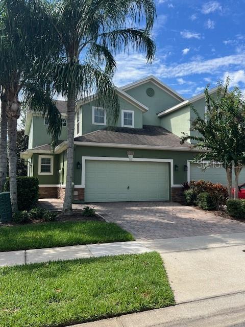 a front view of a house with a yard and garage