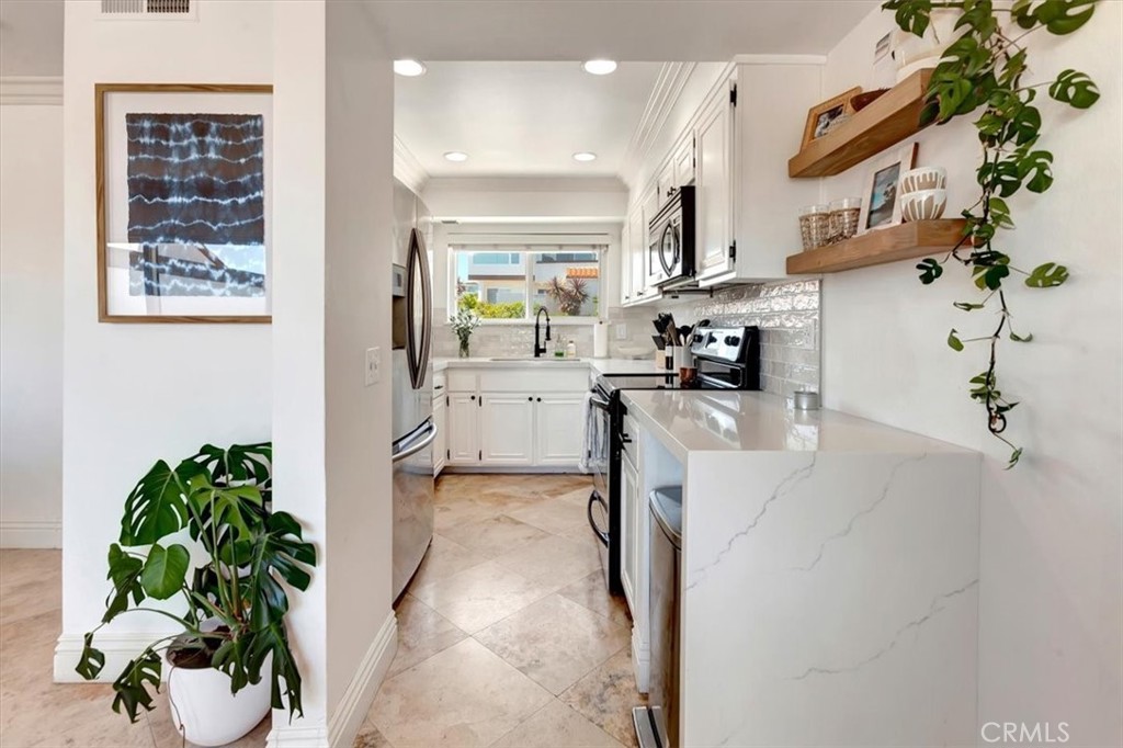 a view of a kitchen with furniture and a potted plant