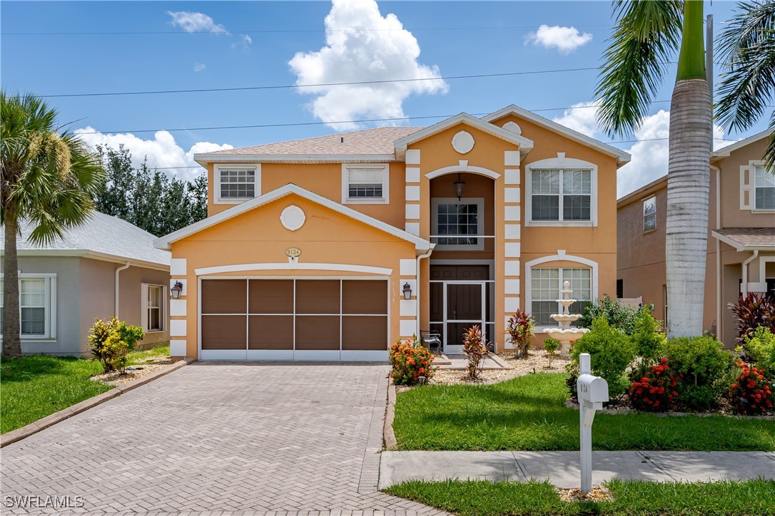 a front view of a house with a yard and garage