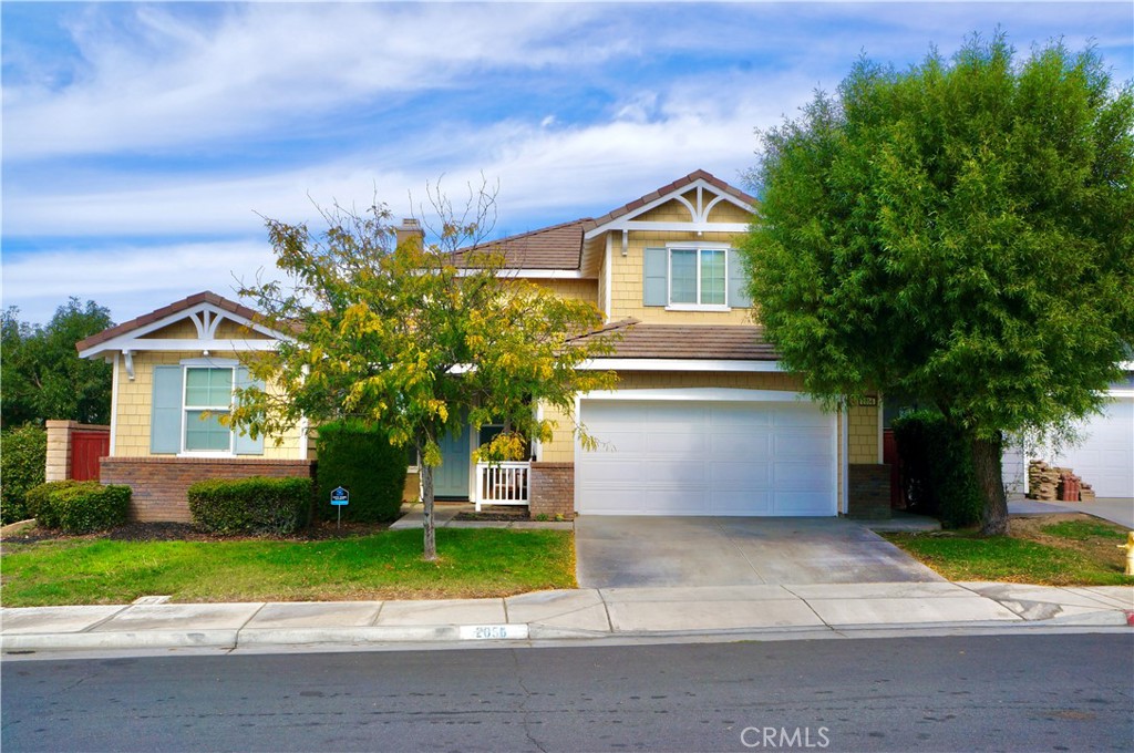 a front view of a house with a yard and a garage