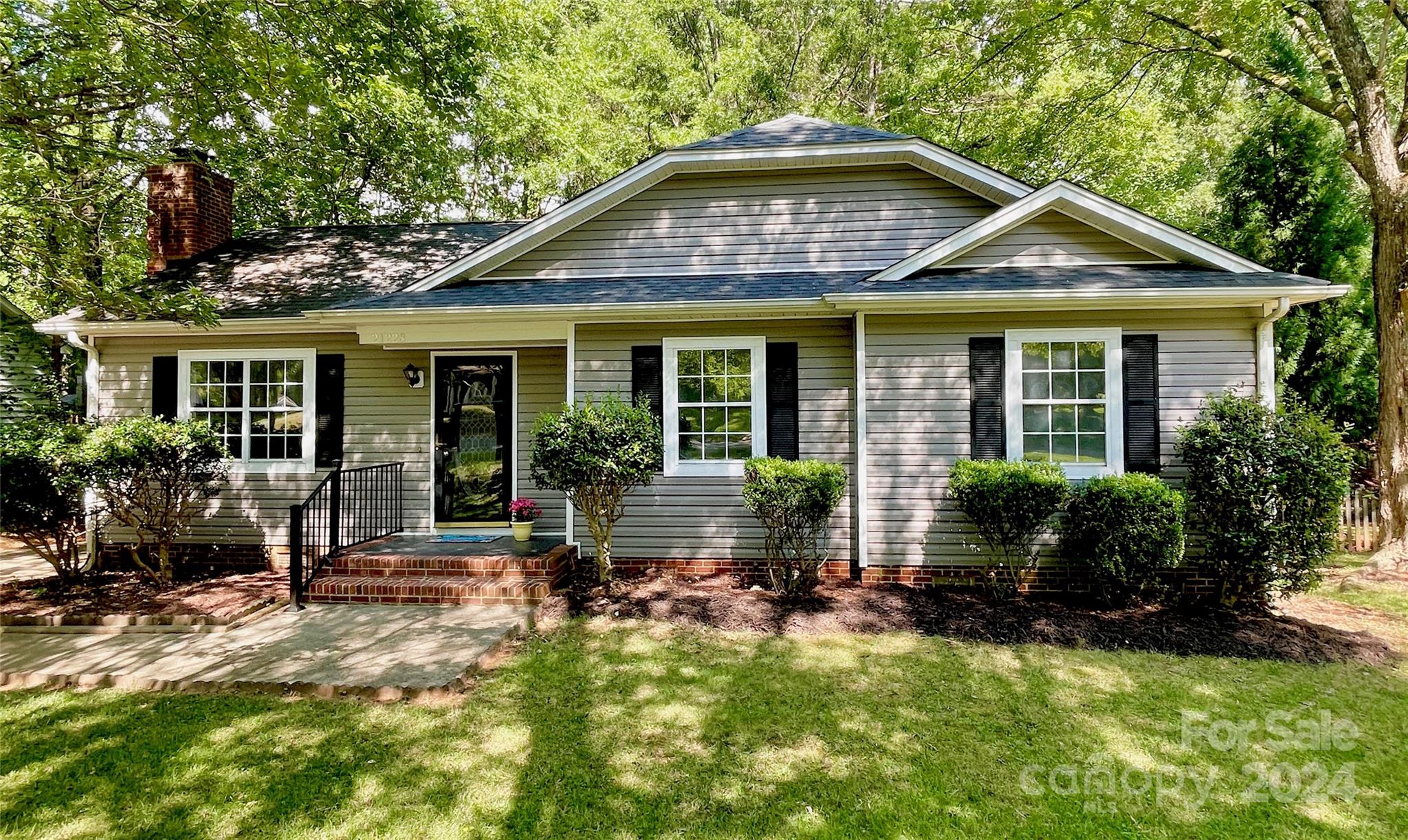 a front view of a house with yard and porch