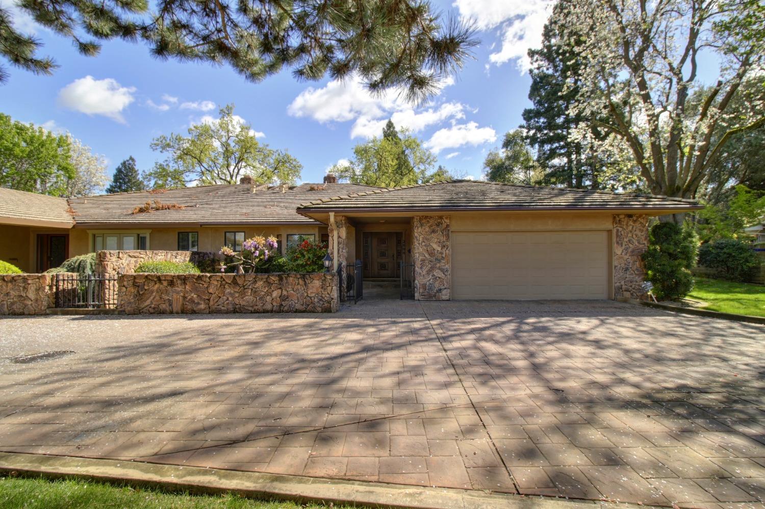 a front view of a house with a yard and a garage