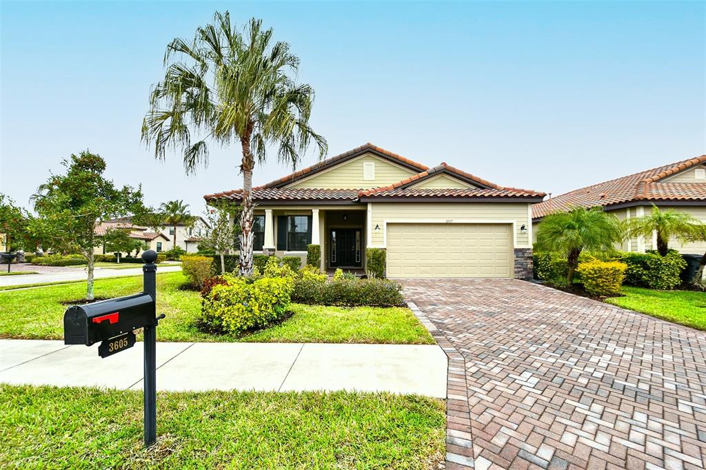 a front view of a house with a yard and garage