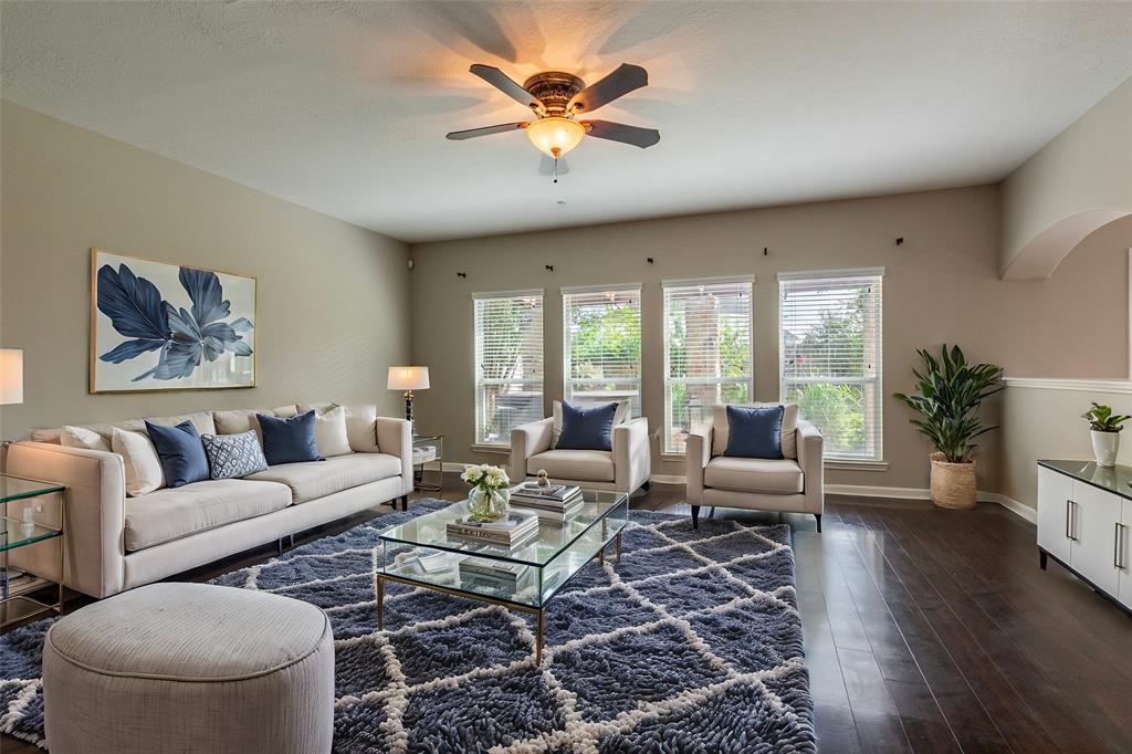 a living room with furniture and wooden floor