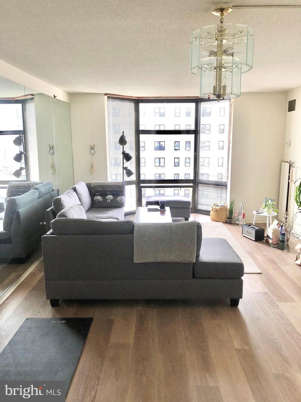 a living room with furniture window and a flat screen tv