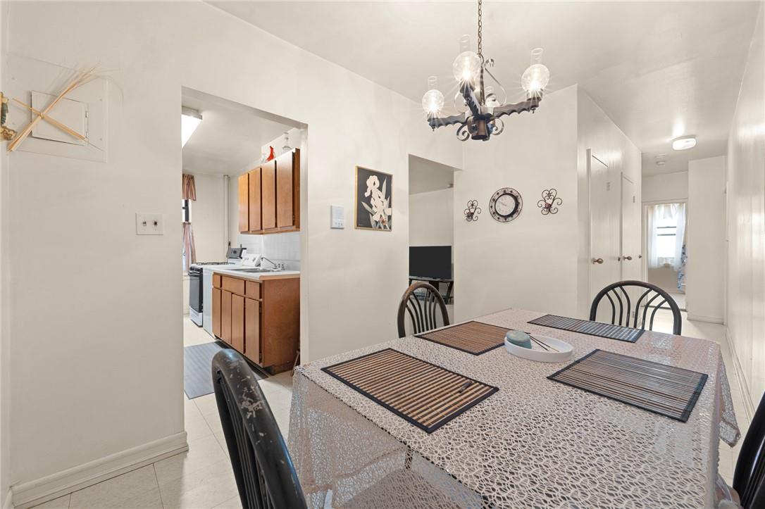 Tiled dining area with sink and an inviting chandelier