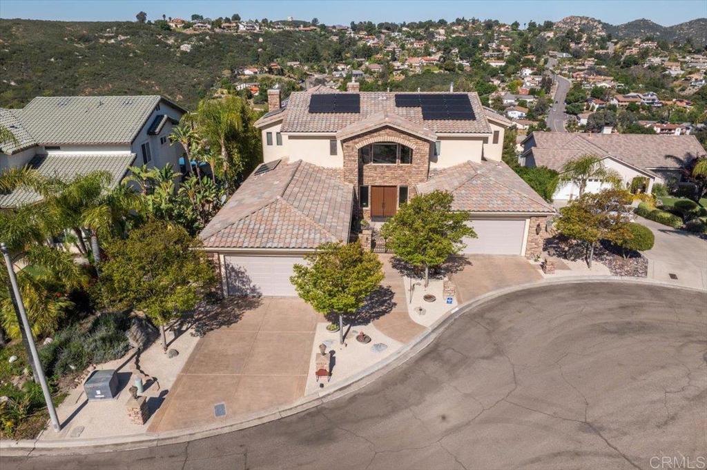 an aerial view of a house with a yard