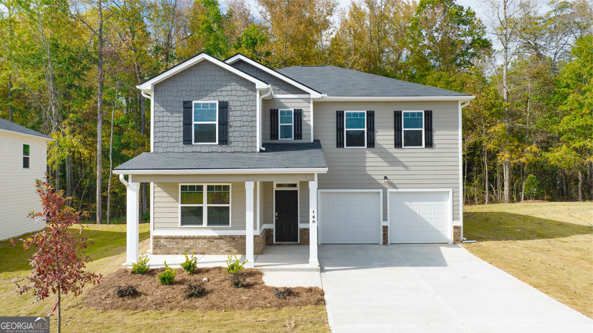 a front view of a house with a yard and garage