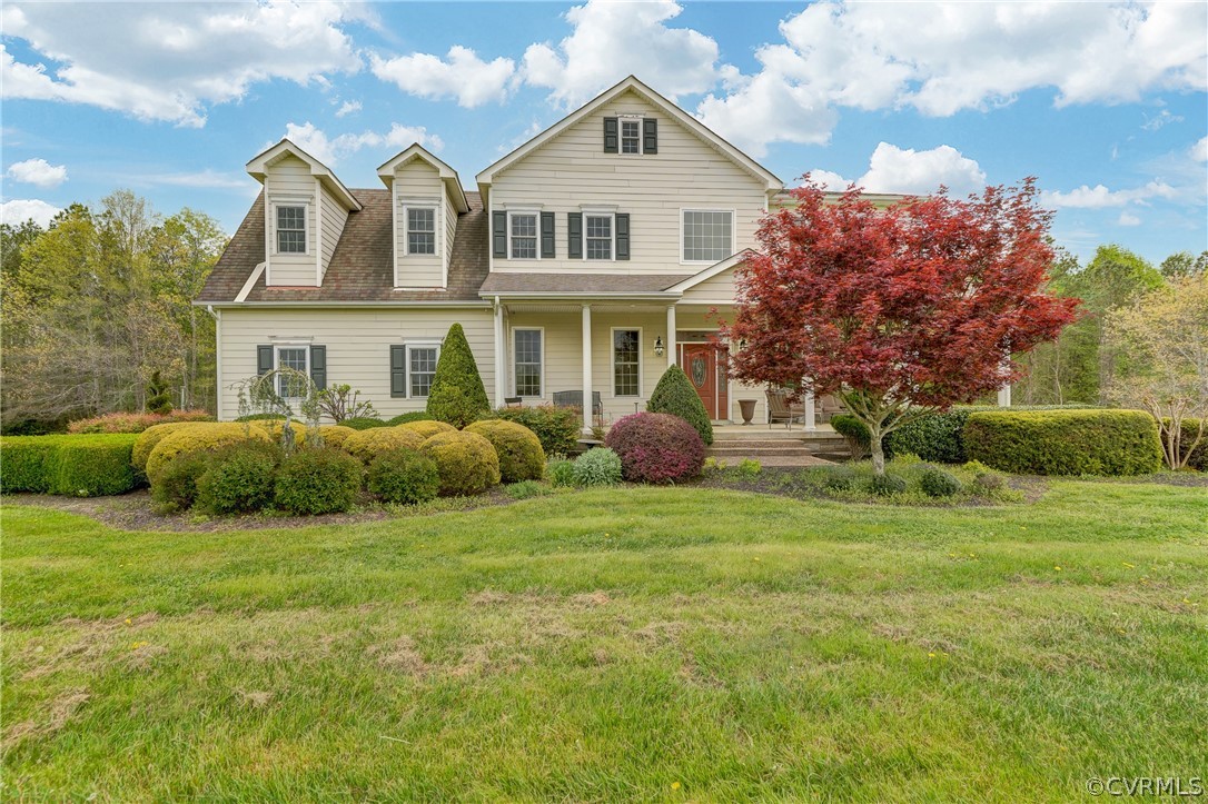 a front view of a house with a garden