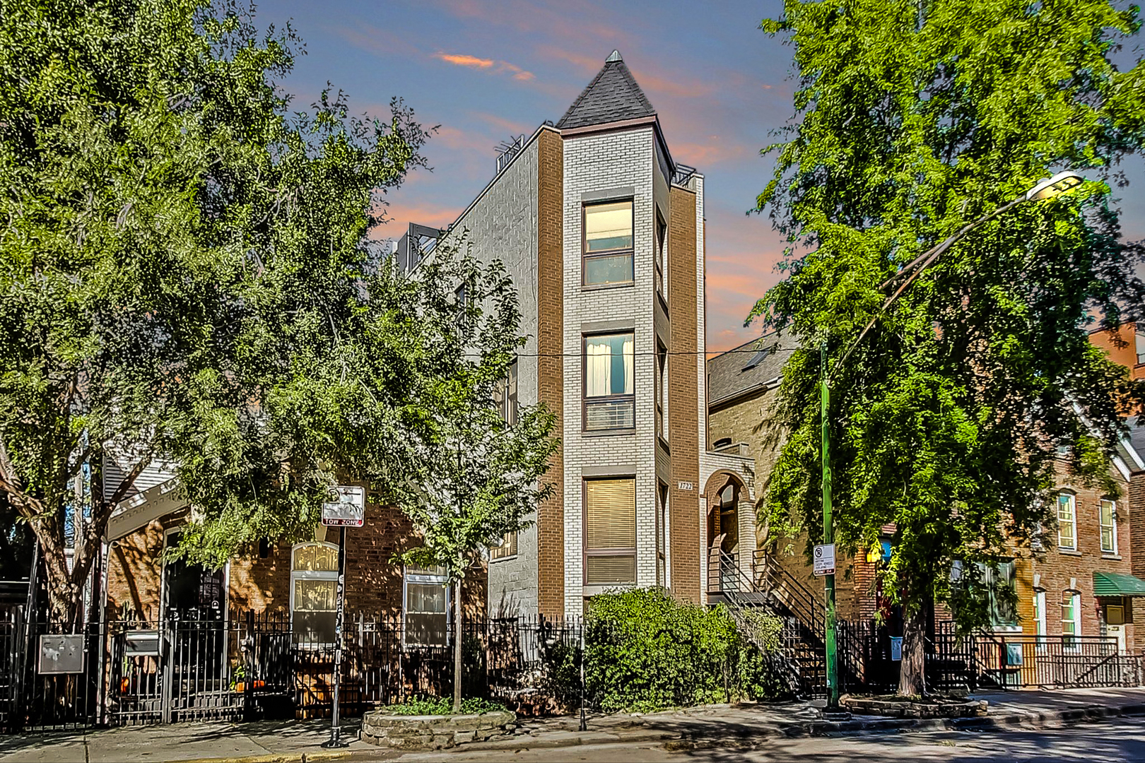 a front view of a building with trees