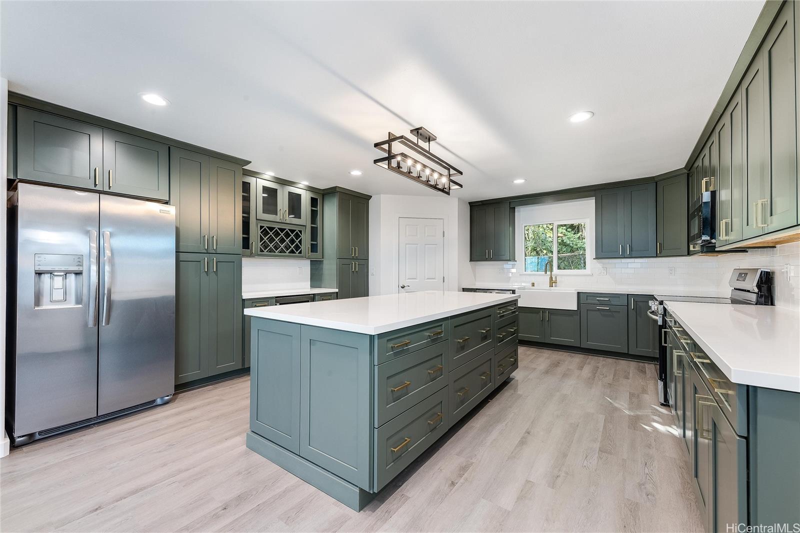 a kitchen with stainless steel appliances granite countertop a sink a stove and a refrigerator