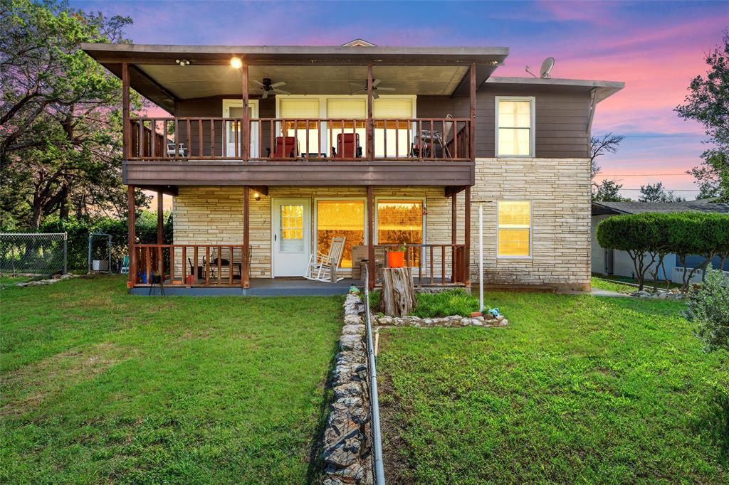 a view of a house with backyard and sitting area