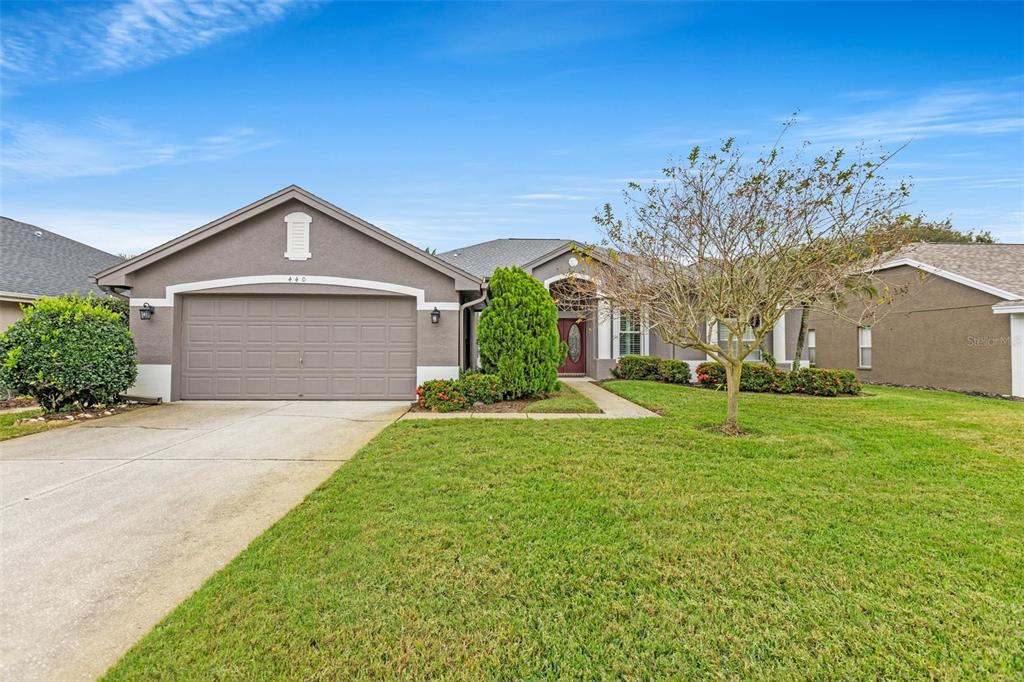 Meticulously maintained landscaping surrounds this 3-bedroom 3-bath contemporary Florida ranch. 