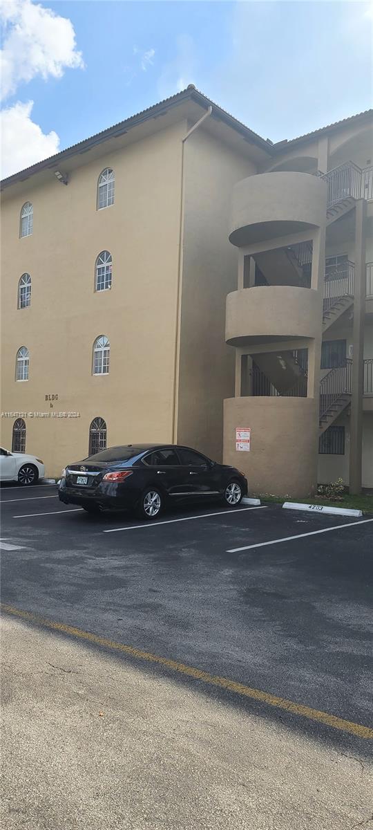 a view of street with a car parked in front of it