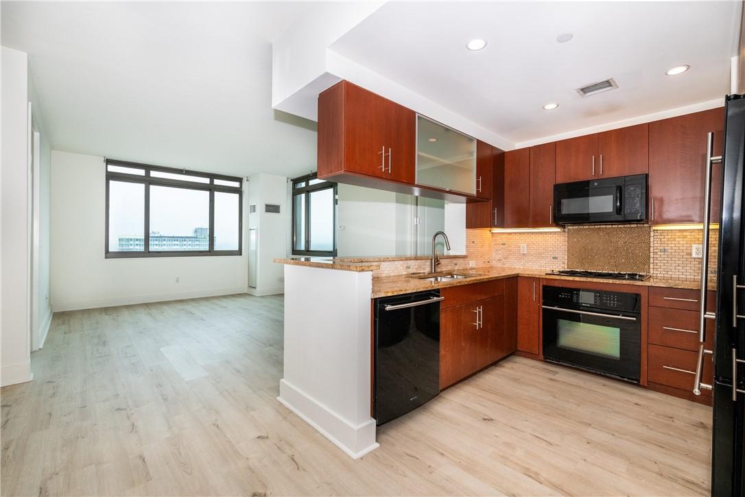 a kitchen with stainless steel appliances granite countertop a stove top oven and sink