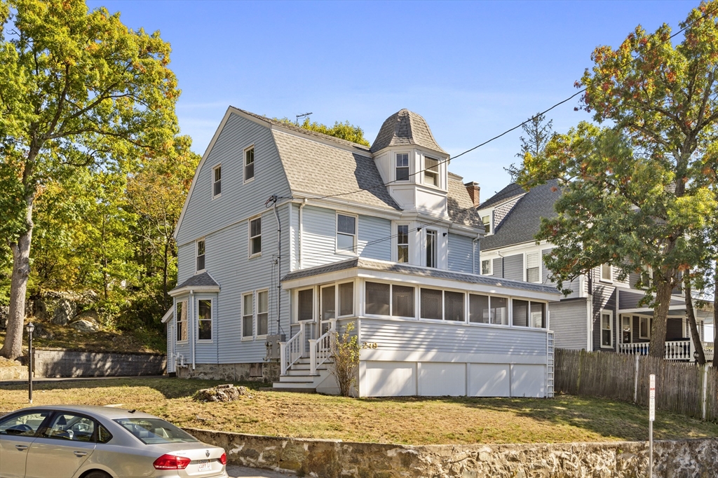 a front view of a house with a garden