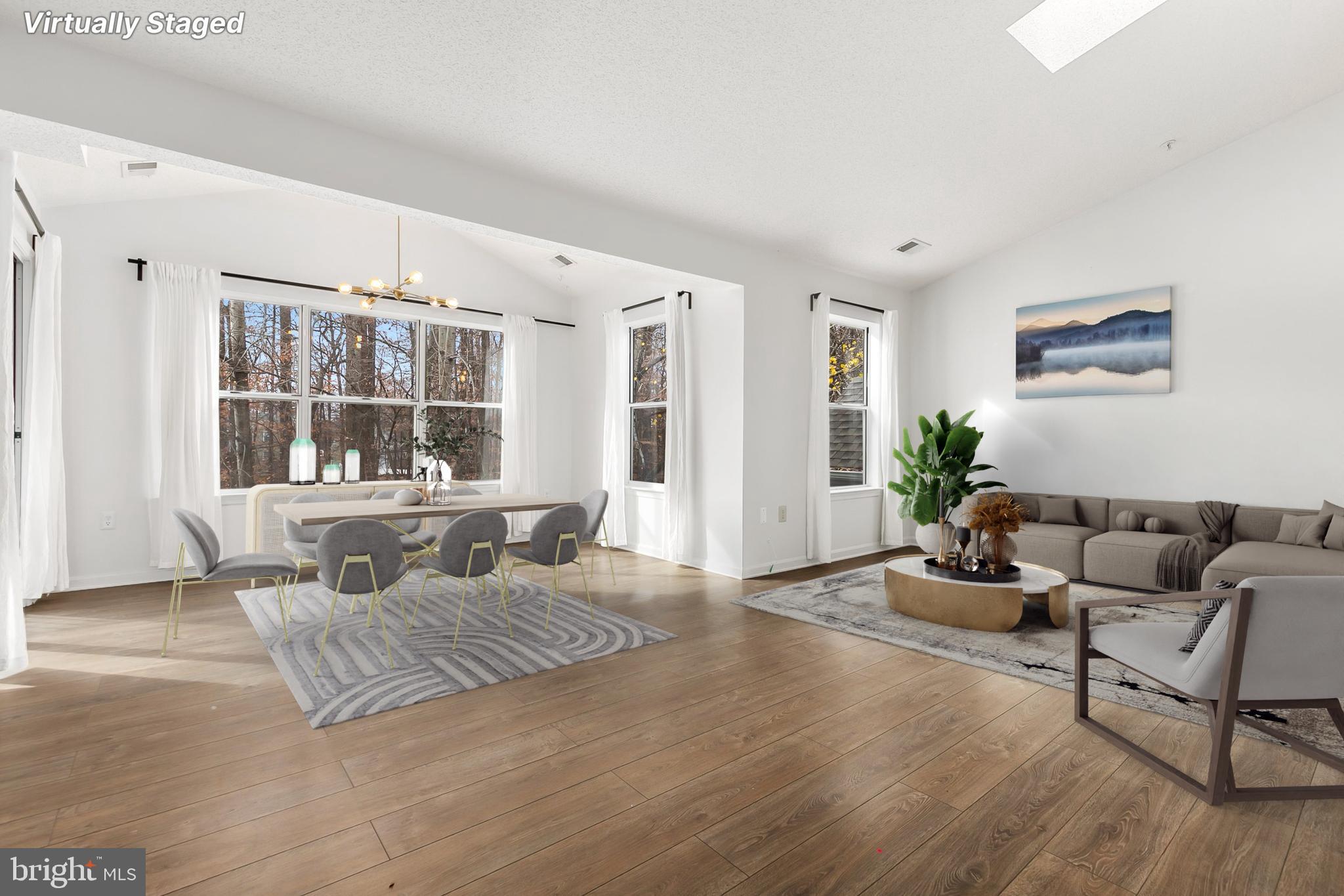 a living room with furniture window and wooden floor