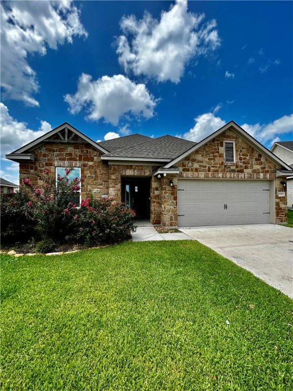 View of front of property featuring a garage and a