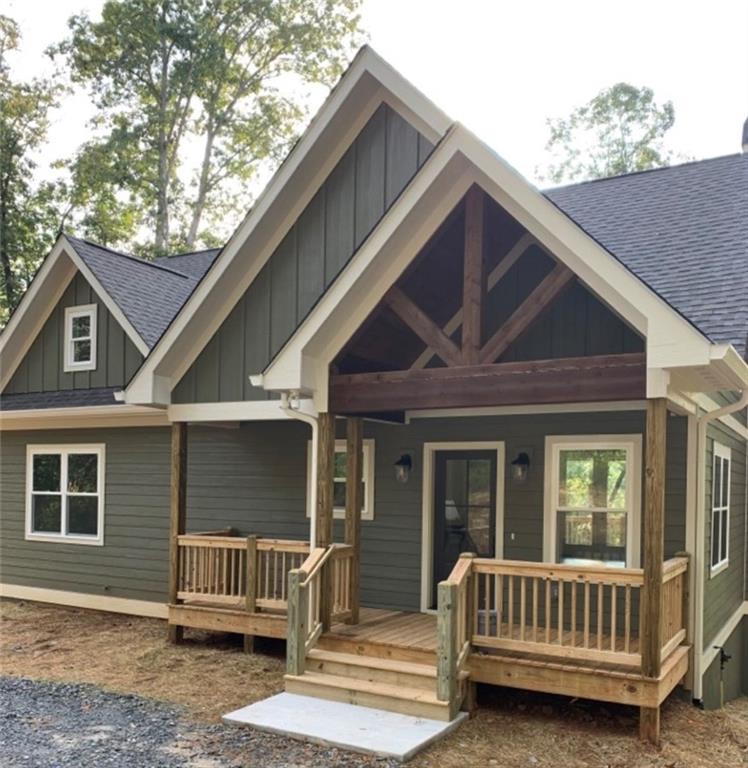 a view of house with a deck and furniture