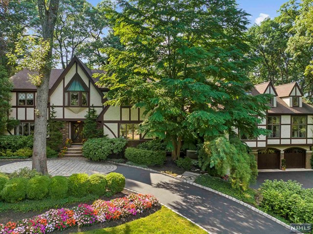 a front view of a house with a yard and a garden