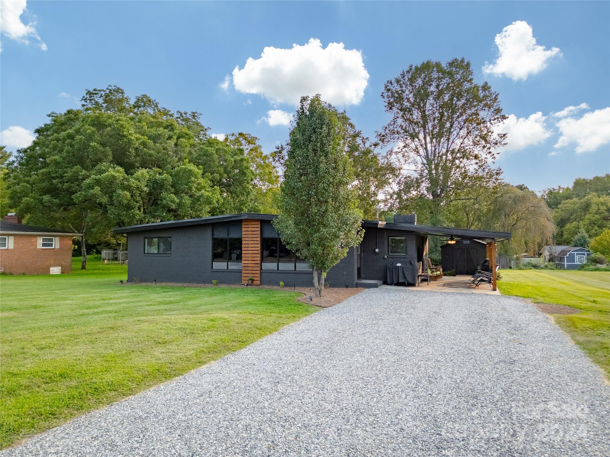 a view of a house with a yard and a garage