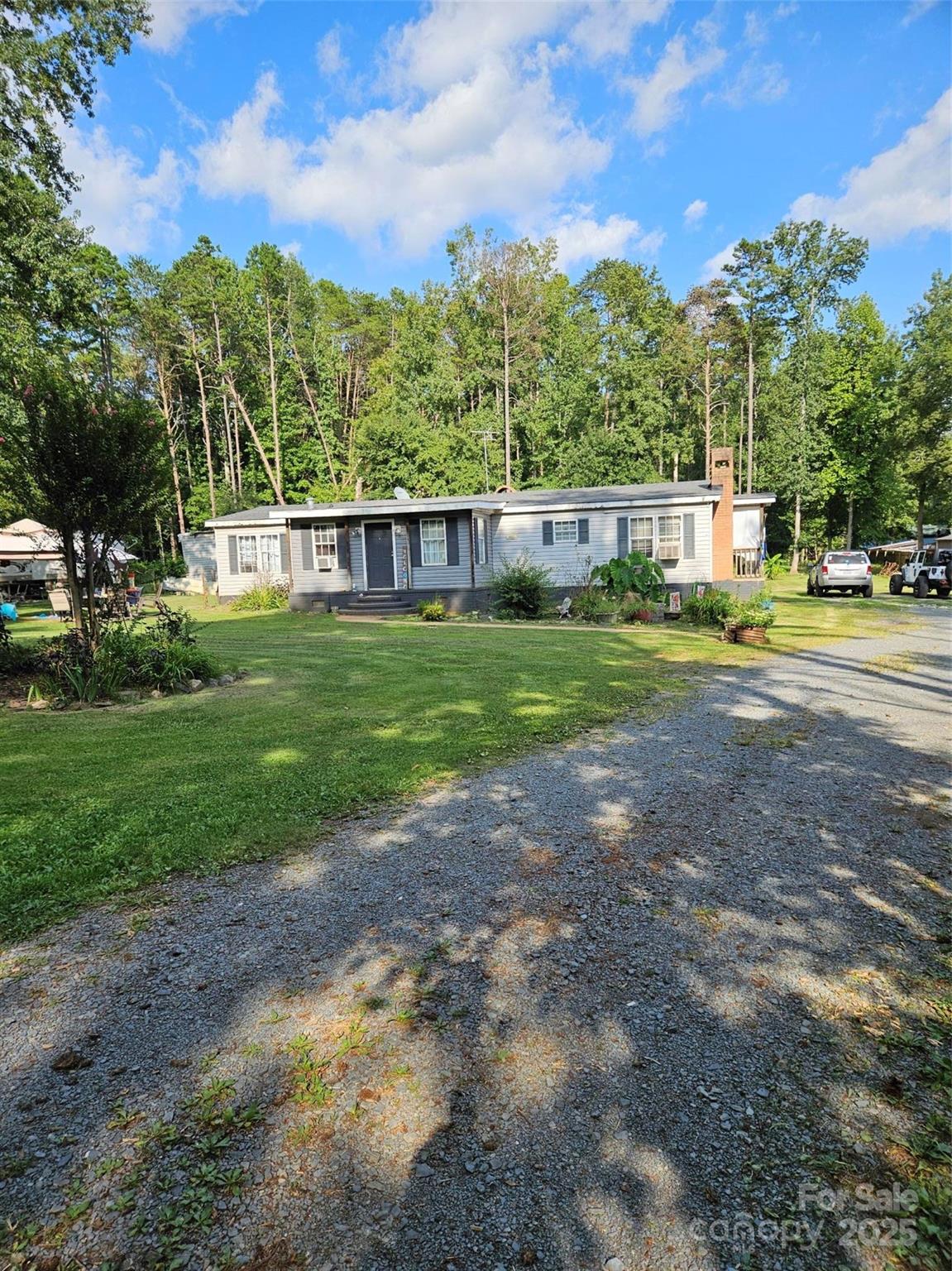 a view of a yard with a house in the background