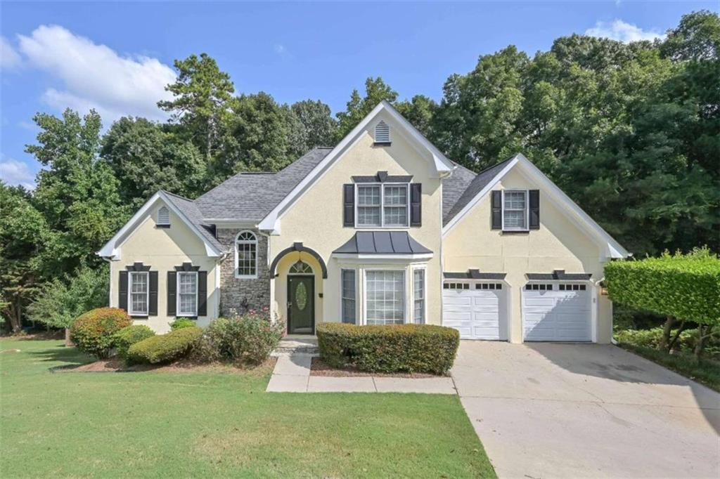 a front view of a house with a yard